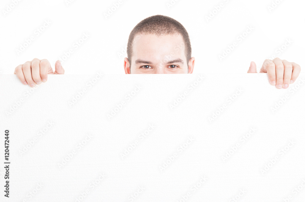 Supermarket seller hiding from big advertising board Supermarket seller hiding from big advertising board