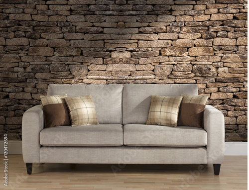 Sofa in Lounge with stone wall © artisan263