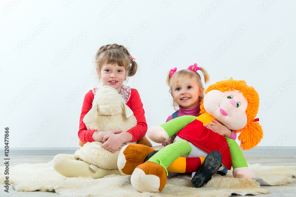 Children posing with soft toys on a white background. Education and development of school and preschool age children. Children posing with soft toys on a white background. Education and development of school and preschool age children.