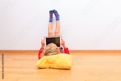 little boy looking at touch pad, home learning