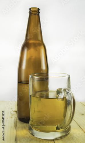 Beer bootle and mug on white background