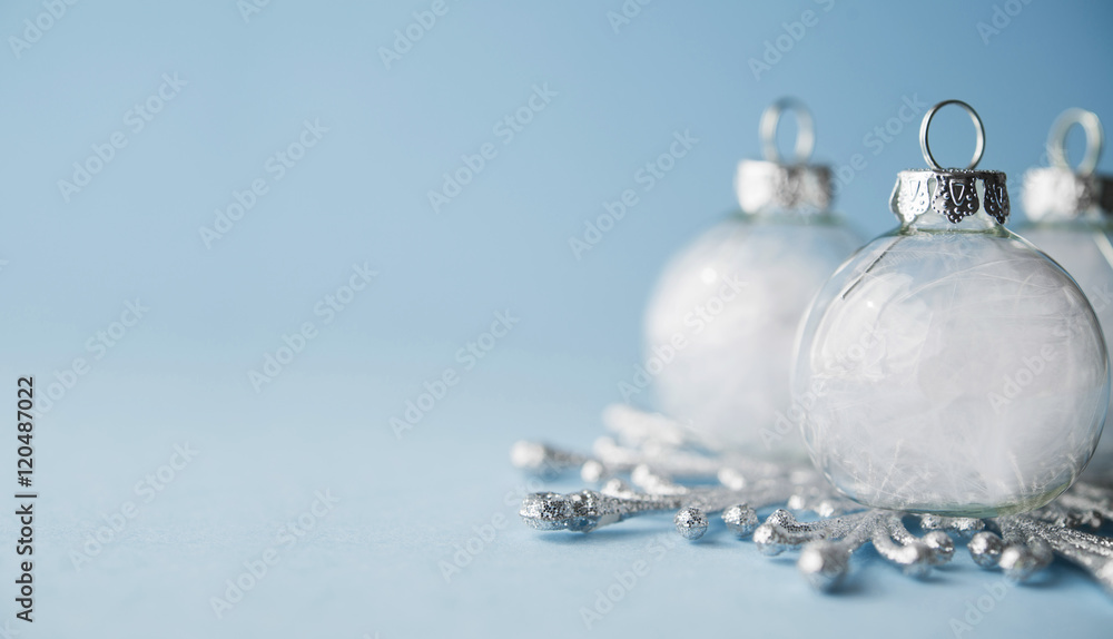 White xmas ornaments on light blue background. Merry christmas card. Winter holiday theme. Space for text. Happy New Year. White xmas ornaments on light blue background. Merry christmas card. Winter holiday theme. Space for text. Happy New Year.