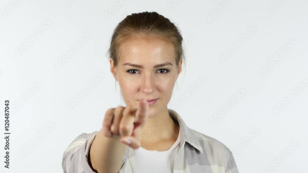 Young girl pointing finger to the camera in front of white background Young girl pointing finger to the camera in front of white background