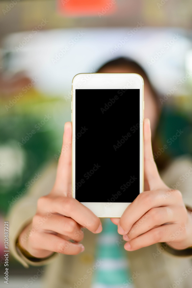 Young woman showing display of mobile cell phone with black scre