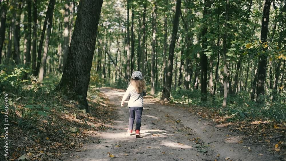 Little girl running away in the forest Little girl running away in the forest