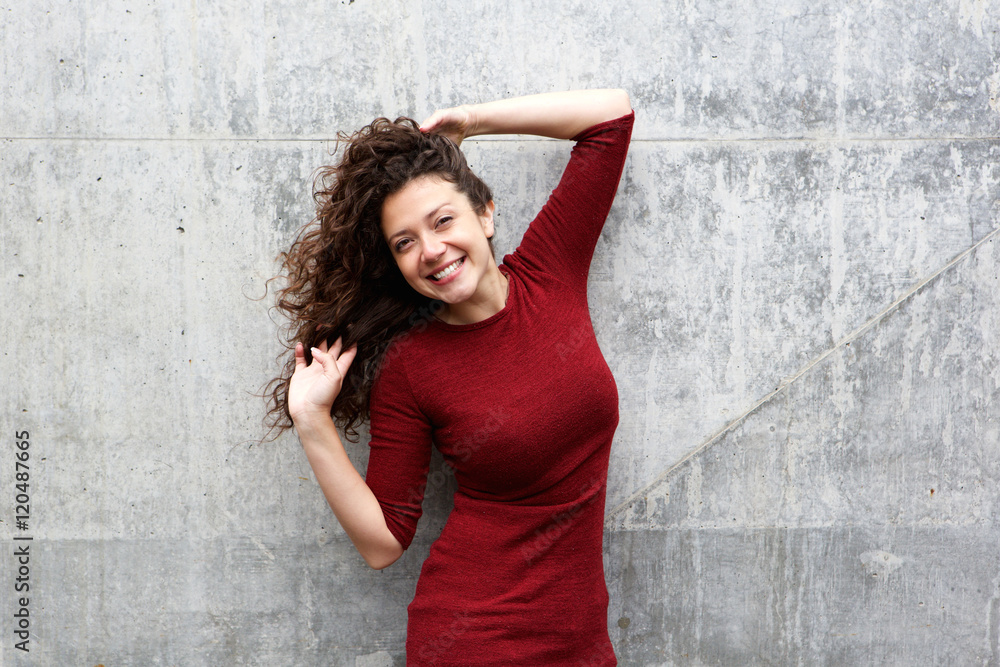 Beautiful female model posing against gray wall Beautiful female model posing against gray wall