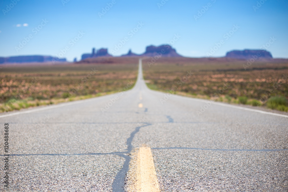 Road trip scene; long road going into scenic canyon landscape in USA Road trip scene; long road going into scenic canyon landscape in USA
