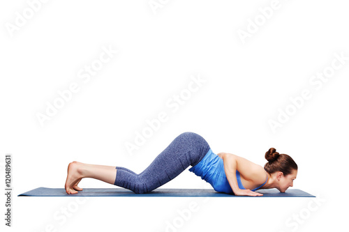 Sporty fit woman practices yoga asana Ashtangasana