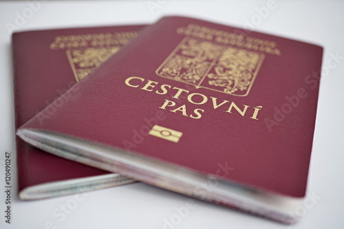 Two isolated red Czech passport with a state symbols (lions and eagles) and captions Czech Republic and European Union in Czech language