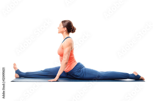 Woman doing Hatha Yoga asana Hanumanasana splits photo