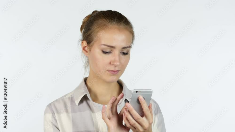 Using Apps in Smartphone, Portrait of Busy Girl, White Background Using Apps in Smartphone, Portrait of Busy Girl, White Background