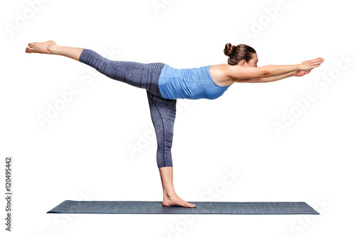 Sporty fit woman practices yoga asana utthita Virabhadrasana 3 photo