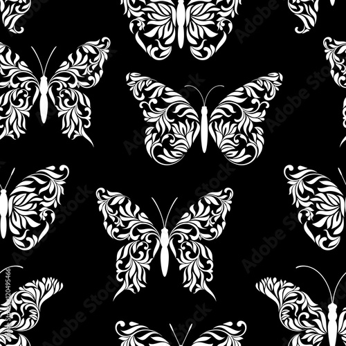 Seamless pattern with beautiful butterflies created from abstract floral tracery on a black background