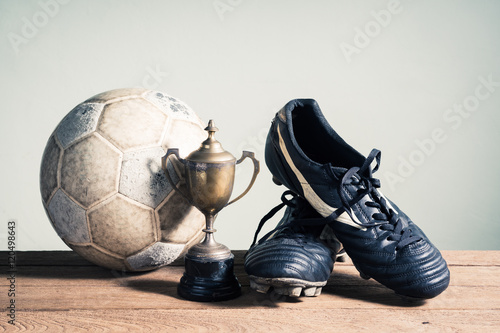 Fotografie still life photography : old football, football shoes and trophy on old wood tab