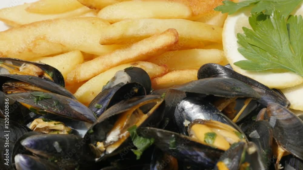 Blue common mussel with french fries and lemon food 4K 2160p 30fps UltraHD footage Potato