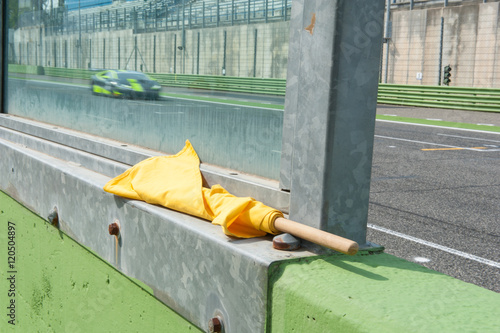Yellow flag danger signal for racing motor sport