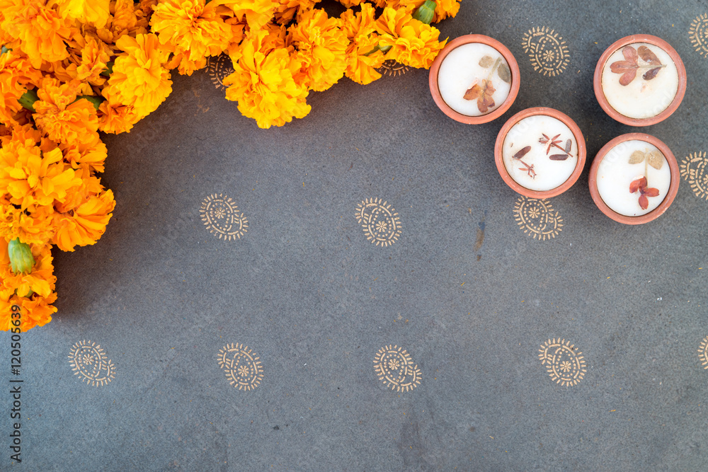 Fototapeta premium Wax diyas made of clay with marigold flowers for hindu religious celebration and festivity 