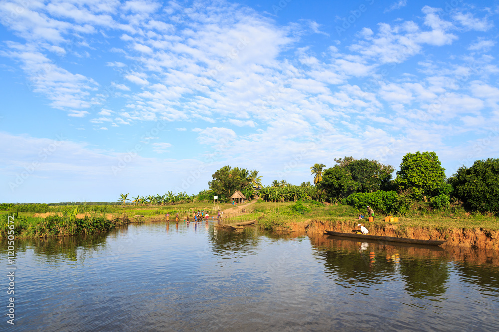 People living on the banks of a river in a tropical African Mada People living on the banks of a river in a tropical African Mada