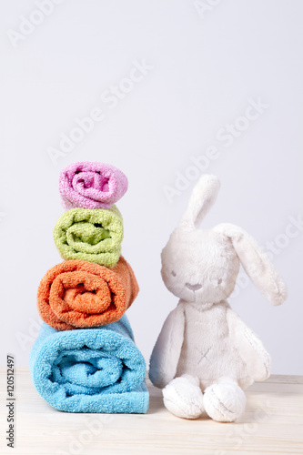 from small to large. towels stacked rolls. soft toy bunny