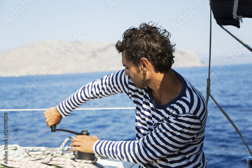 Man in action of pulling rope