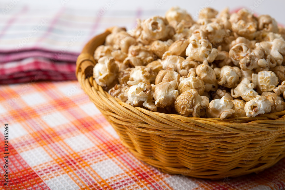 caramel popcorn in a basket on a napkin caramel popcorn in a basket on a napkin