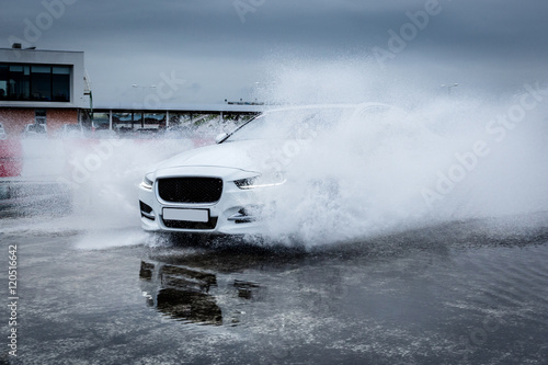 Sportcar riding through the rain