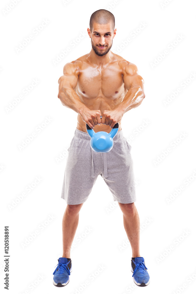 Young fit man lifting a kettlebell, isolated on white background