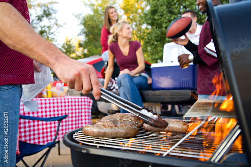 Tailgating: Bratwurst or Sausage On The Grill At Tailgate Party photo