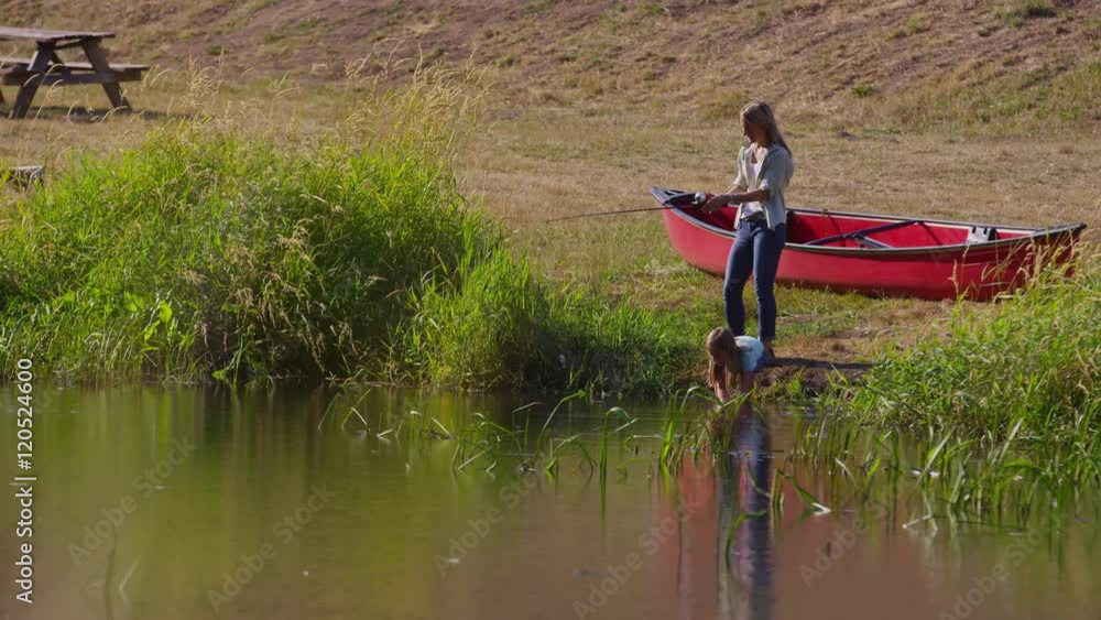 Mother and daughter fishing at lake Mother and daughter fishing at lake