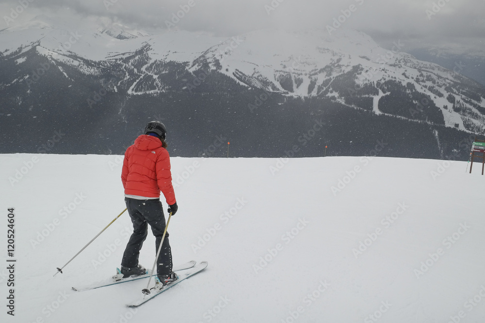 Woman skiing on snow covered landscape, Whistler, British Columb