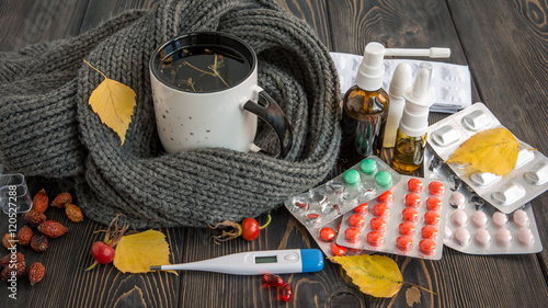 Pills, nose drops and hot tea with lemon for colds, treatment of , flu runny