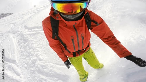 Snowboard fail, snowboarding in powder and falling down in deep snow, face view
