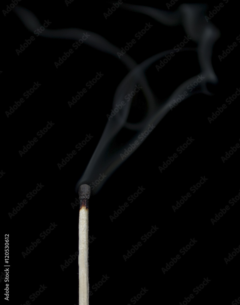 Ignition of a match, with smoke on dark background Ignition of a match, with smoke on dark background