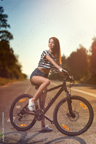 girl on a bicycle at sunset © sheikoevgeniya
