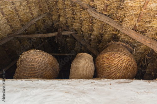 Wicker baskets under a thatched roof in the Ukrainian peasant dw