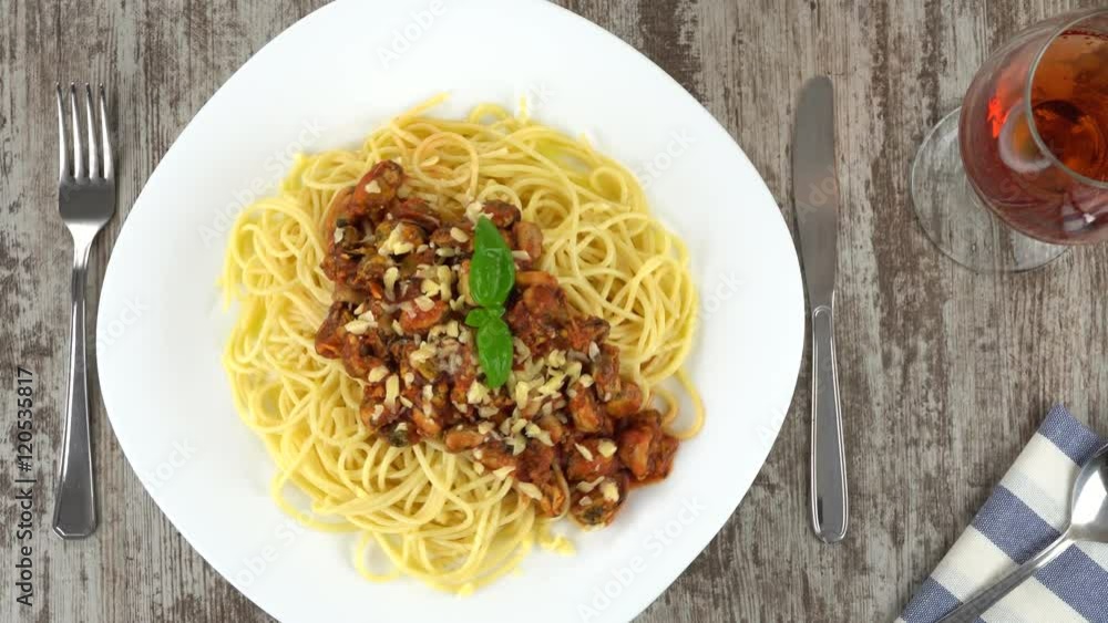 Freshly cooked delicious homemade pasta with mussels in tomato souce and cheese rotating. Seamless loopable. Prores, 4K. Freshly cooked delicious homemade pasta with mussels in tomato souce and cheese rotating. Seamless loopable. Prores, 4K.