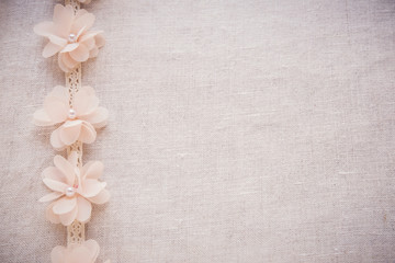 Flowers and lace on linen, copy space toning vintage wedding background