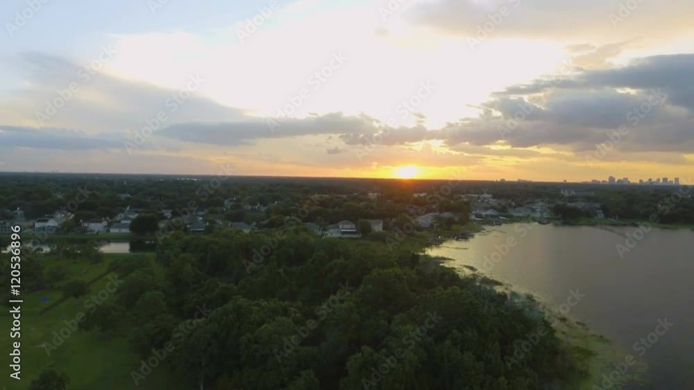 Aerial pan of a beautiful Orlando sunset with the suburbs in the foreground and the city skyline in the background. Aerial pan of a beautiful Orlando sunset with the suburbs in the foreground and the city skyline in the background.