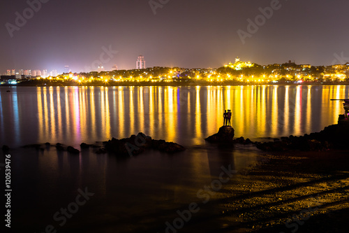 Three boys sculpture at nighy in Huiquan Bay, Yellow sea Shinan district, Qingdao, Shandong province, China photo