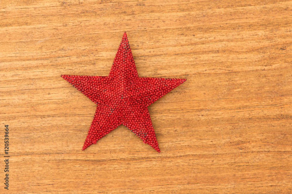 Bright red Christmas star on a wooden background Bright red Christmas star on a wooden background