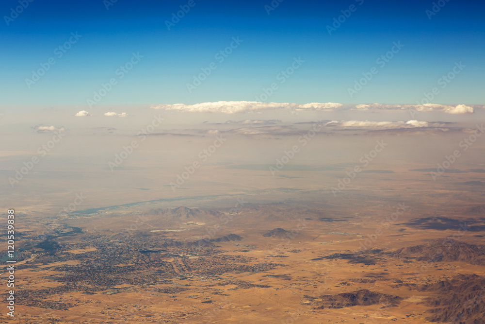 Aerial view of clouds over the land, the landscape. The texture of the scenic sky and desert Sands in the United States. 