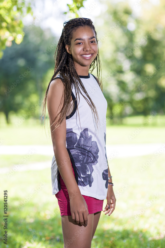 Pretty African American Teenage Girl Posing Outside in Park Pretty African American Teenage Girl Posing Outside in Park