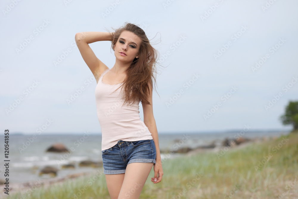 Young beautiful girl posing on the beach