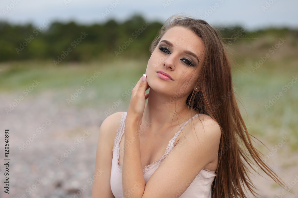 Young beautiful girl posing on the beach Young beautiful girl posing on the beach