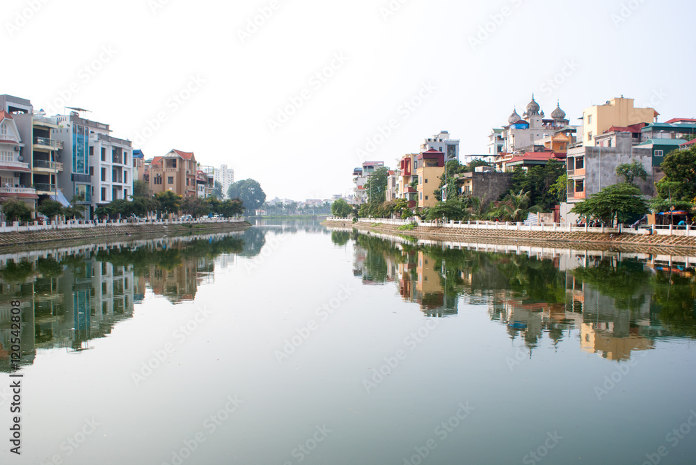 Ladnscape of Hanoi with buildings reflected in the river