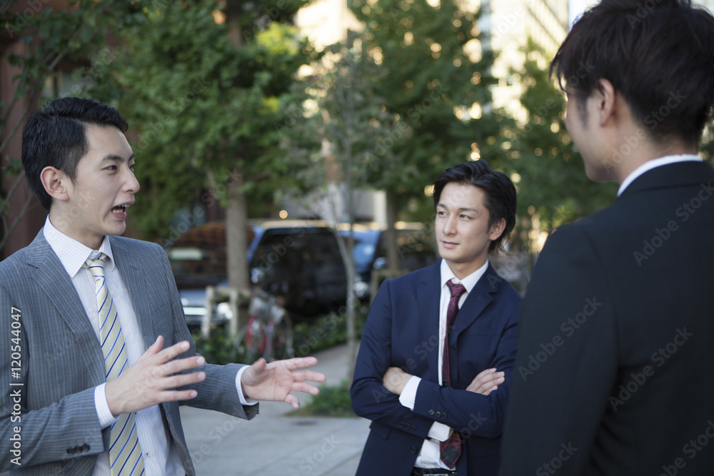 Businessman who has been the stand talking in the office district Businessman who has been the stand talking in the office district