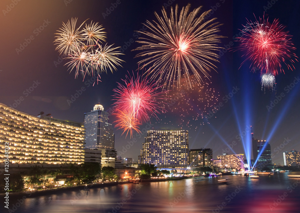 Celebration Fireworks over the river with bangkok cityscape at night scene