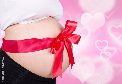 Wallpaper Mural close up pregnant woman with red ribbon gift on belly on heart b Torontodigital.ca