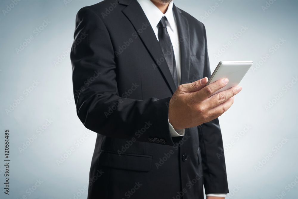Corporate male executive messaging via phone Corporate male executive messaging via phone