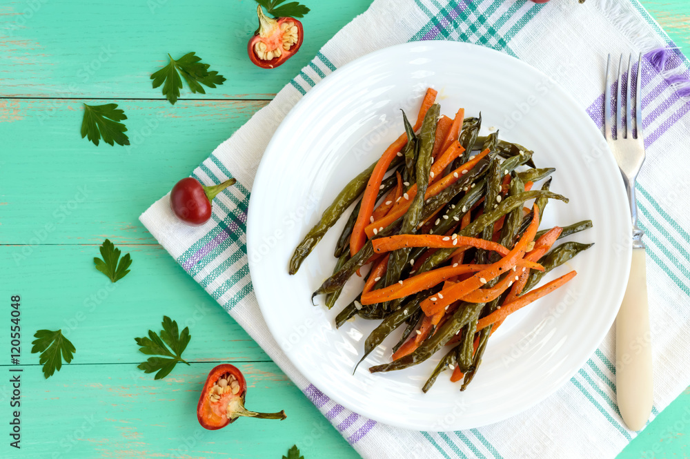 Baked green beans and carrots - vegan diets. The top view Baked green beans and carrots - vegan diets. The top view